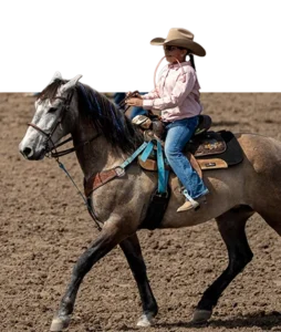 A young Goat Tying competitor riding a grey horse